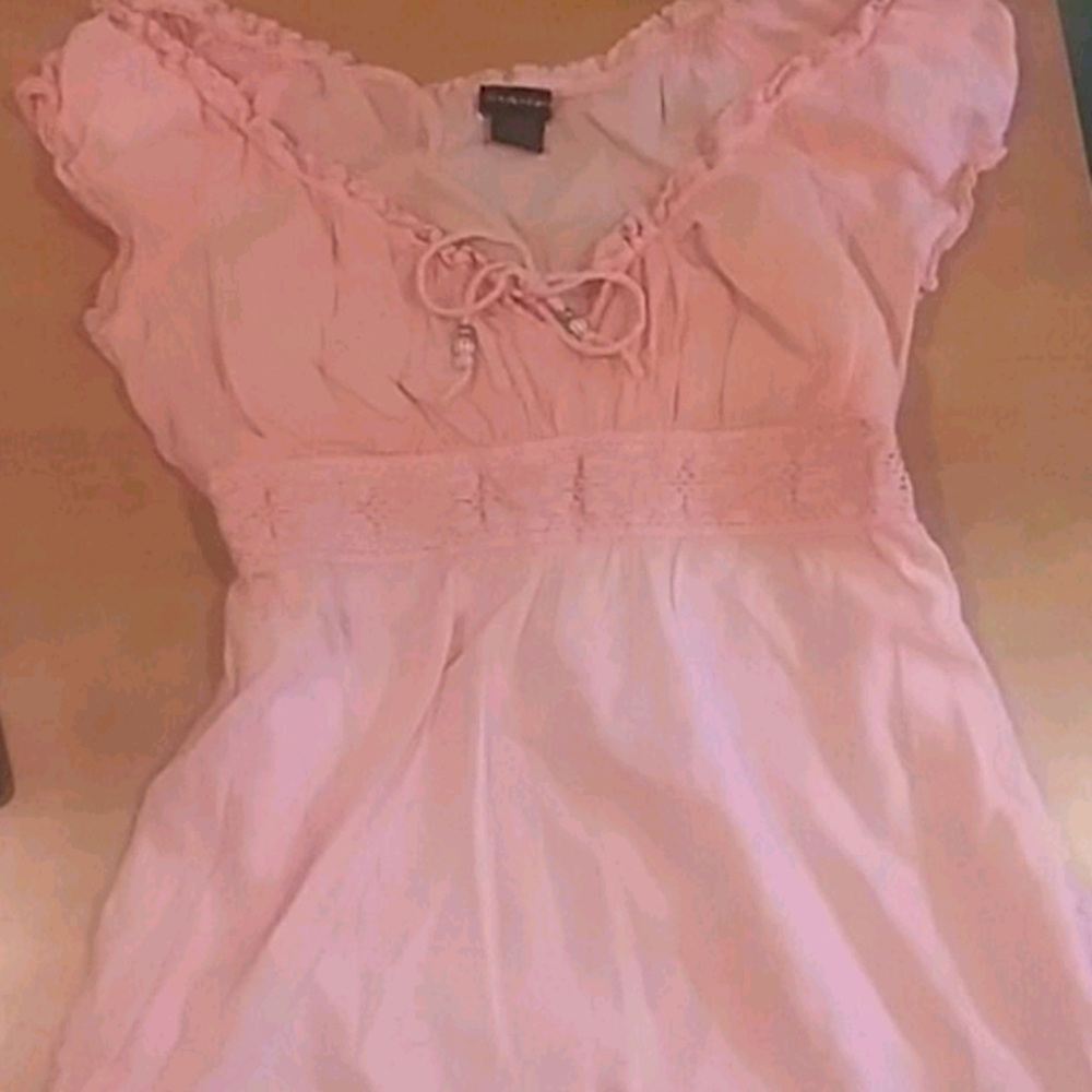 Pink blouse with tie.
